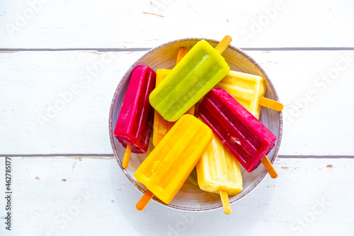 Bowl with colorful popsicles photo