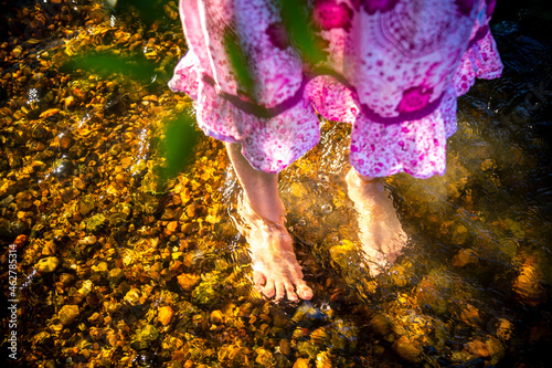 Feet of girl standing in a brook photo