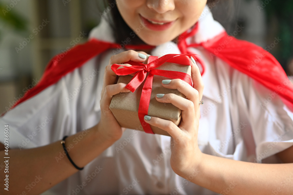 Female holding Christmas gift with Red ribbon. Female holding Christmas gift with Red ribbon.