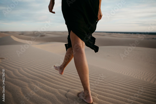 Crop view of woman walking barefoot on sand dune, Algodones Dunes, Brawley, USA