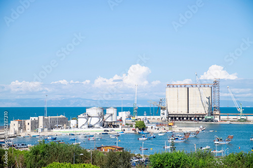 Italy, Apulia, Barletta, Boats in front of commercial dock