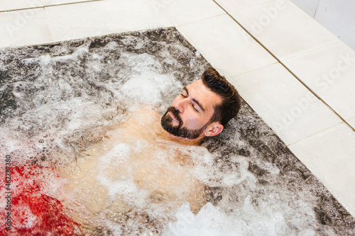 Man enjoying the whirlpool in a spa photo