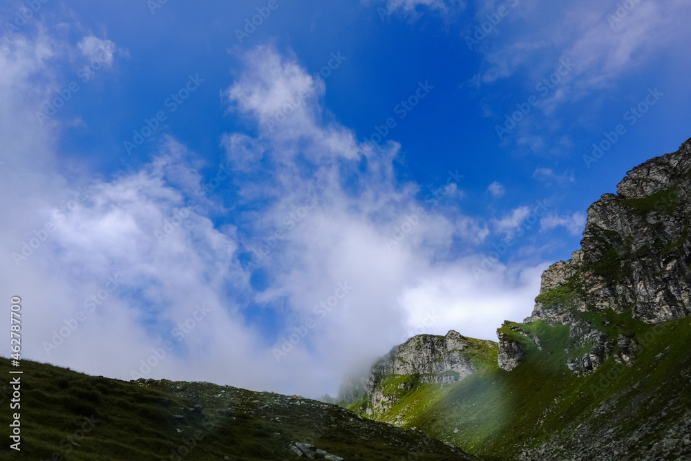 fog and blue sky while hiking in the mountains