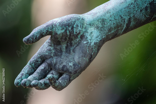 Weathered arm of bronze statue photo