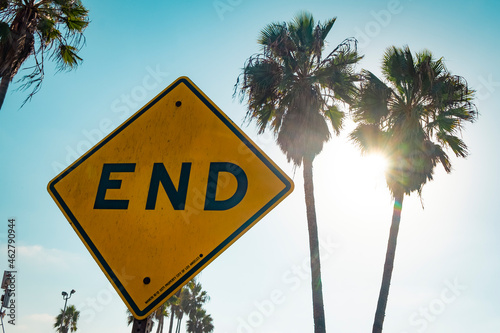 USA, California, Los Angeles, Venice, sign End against palms and sun photo