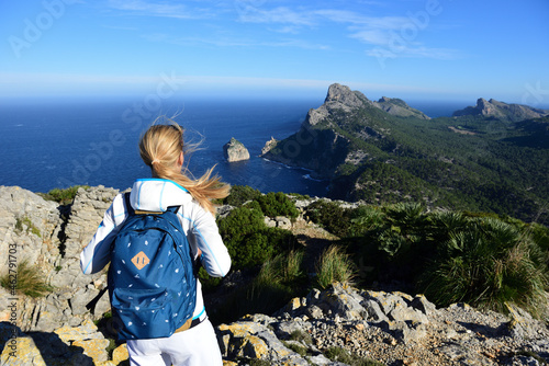 Female hiker enjoying view from Cap Formentor, Balearic Islands, Spain photo