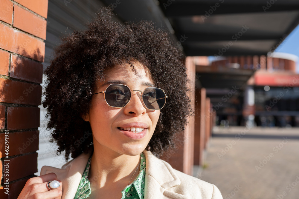 Afro young woman with sunglasses during sunny day Afro young woman with sunglasses during sunny day