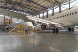 Passenger airplane on maintenance repair check in hangar. Aircraft concept