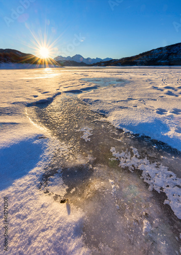 Italy, Abruzzo, Gran Sasso e Monti della Laga National Park, Lake Campotosto at sunrise in winter photo