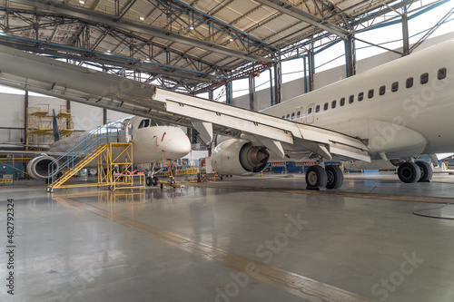 Passenger airplane on maintenance repair check in hangar. Aircraft concept