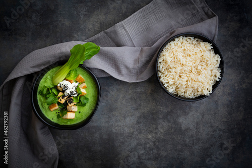 Green thai curry with spinach, pak choi, tofu, sour cream, black sesame and jasmine rice photo