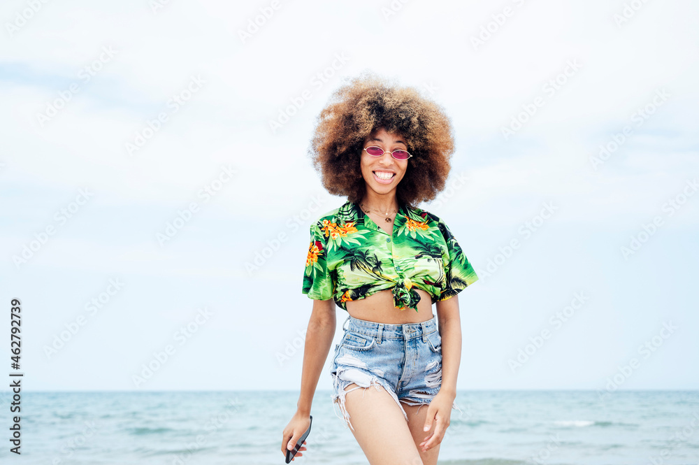 Young smiling woman with smartphone at beach Young smiling woman with smartphone at beach