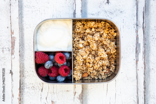 Box with granola, greek yogurt, blueberries and raspberries