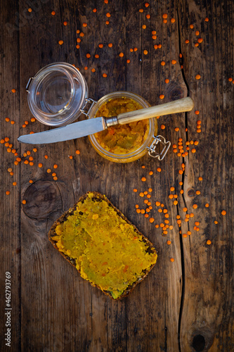 Jar of homemade red lentil paste and slice of wholegrain bread