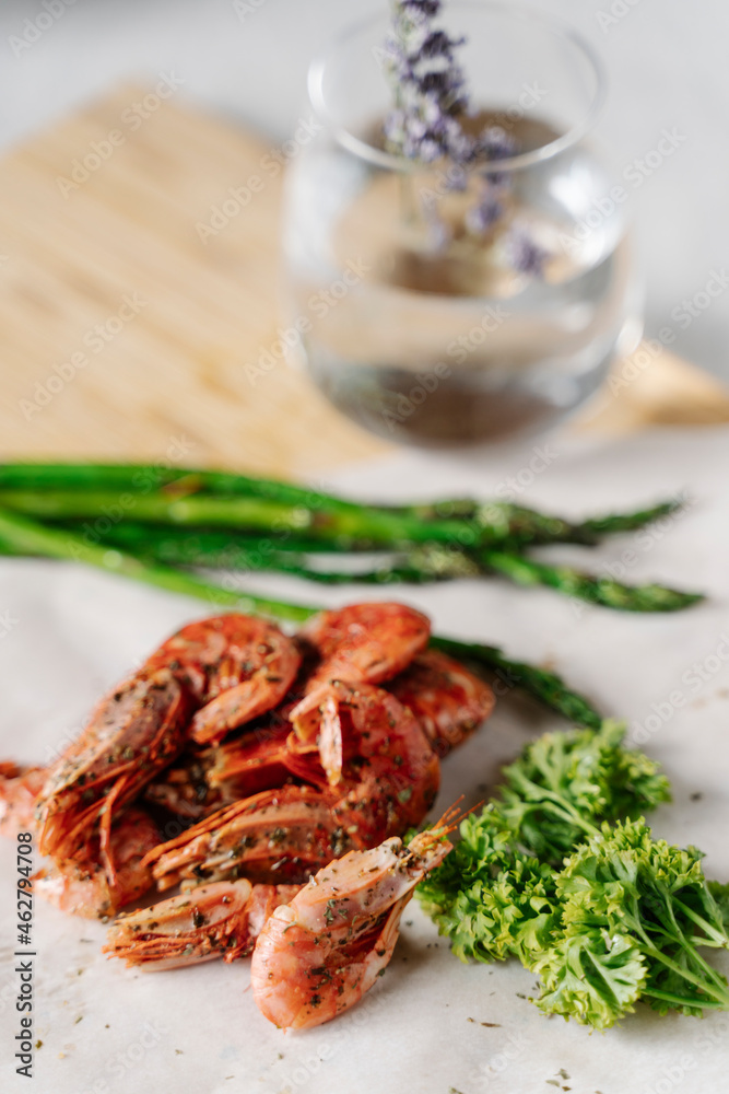 Grilled prawns, parsley and asparagus on wooden cutting board Grilled prawns, parsley and asparagus on wooden cutting board