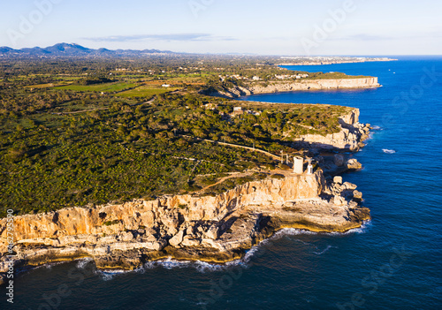 Spain, Balearic Islands, Santanyi, Aerial view of coastal cliffs and Torre den Beu photo
