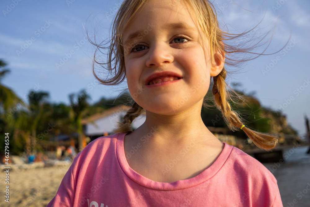 Portrait of smiling little girl on the beach, Willemstad, Curacao Stock ...