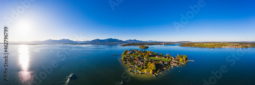 Germany, Bavaria, Aerial panorama of sun shining over Frauenchiemsee islet photo