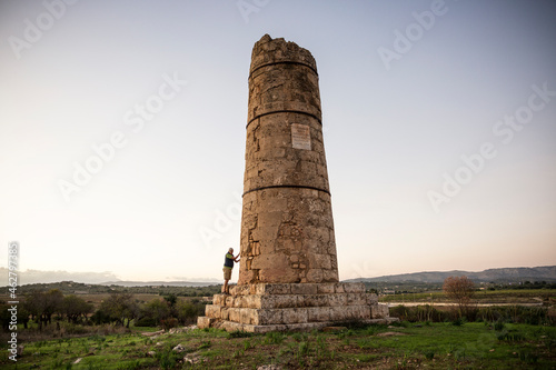 Italy, Sicily, Helorus, senior man standing at a column of a hellenistic tomb photo