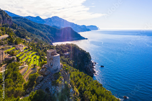 Spain, Balearic Islands, Banyalbufar, Aerial view of blue Mediterranean Sea andÔøΩTorreÔøΩdesÔøΩVerger watchtower photo