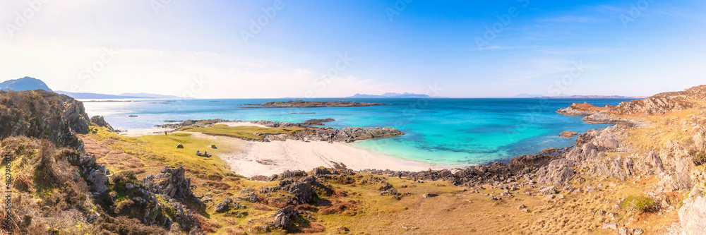 Panoramic shot of Smirisary Beach while The Small Isles of Rum, Eigg and Muck in background, Smirisary Beach, Lochailort, Scotland, UK Panoramic shot of Smirisary Beach while The Small Isles of Rum, Eigg and Muck in background, Smirisary Beach, Lochailort, Scotland, UK