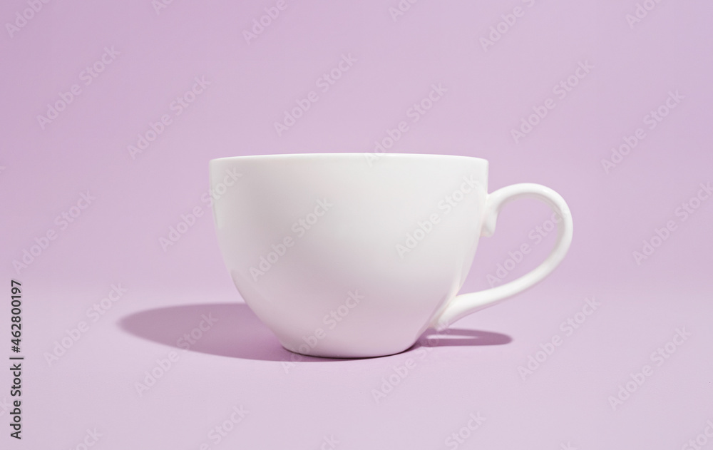 White mug on a solid purple background White mug on a solid purple background