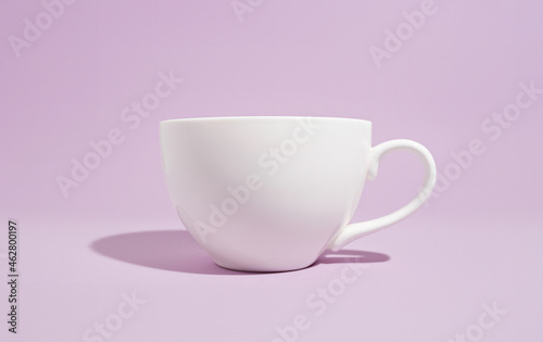 White mug on a solid purple background