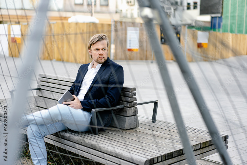 custom made wallpaper toronto digitalBusinessman sitting on a bench behind ramshackle hoarding