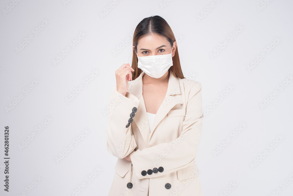 portrait of young businesswoman wearing a surgical mask over white background studio portrait of young businesswoman wearing a surgical mask over white background studio