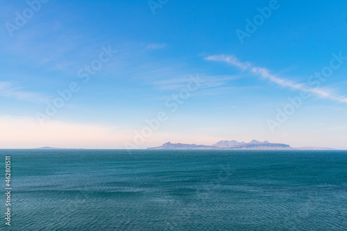 Scenic view of sea with islands Eigg, Rum and Muck in background against sky, Lochailort, Scotland, UK