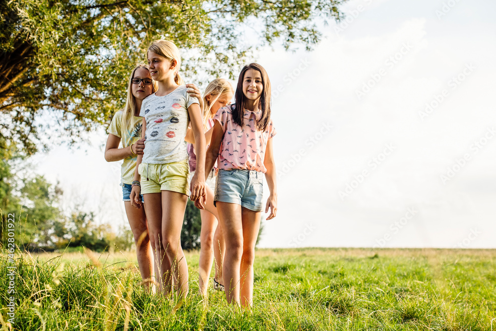 Girls standing on a field in the countryside Girls standing on a field in the countryside