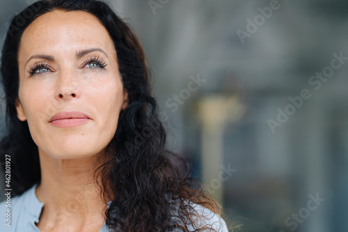Close-up of woman with gray eyes contemplating outdoors