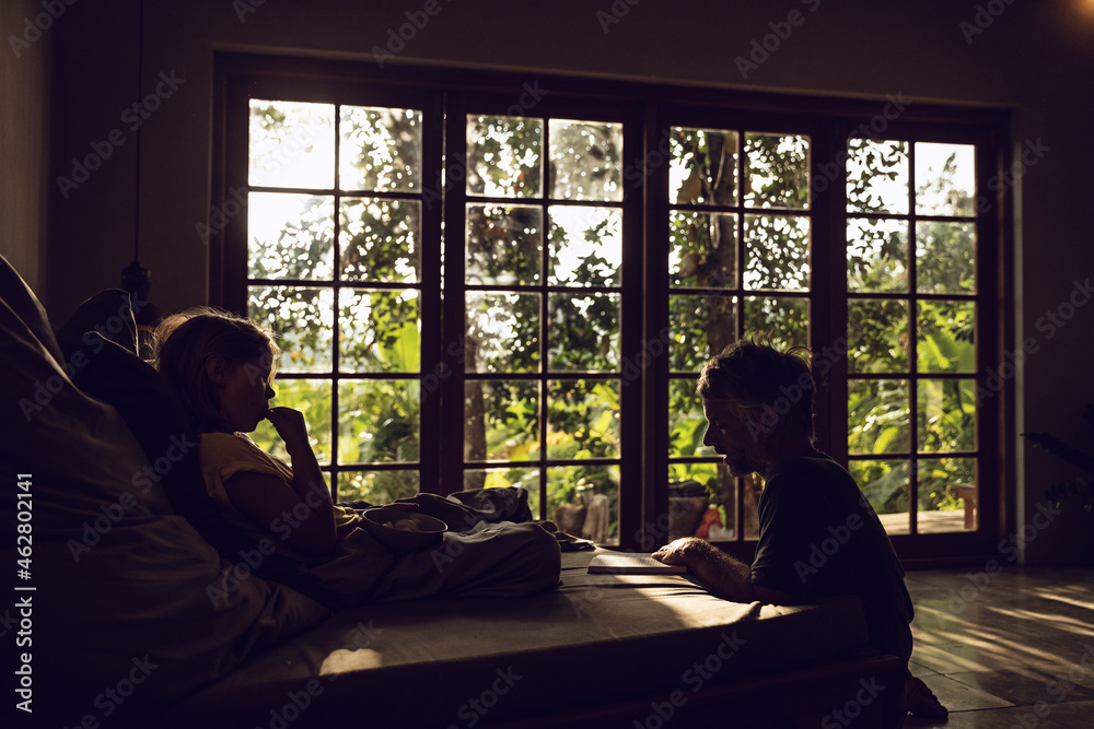 Father and daughter in bedroom in tropical surrounding Father and daughter in bedroom in tropical surrounding