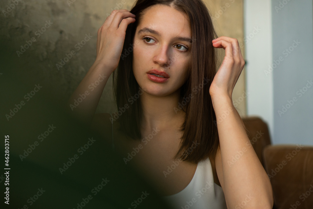 Close-up portrait of a beautiful young caucasian woman with natural brown hair.