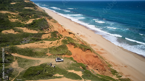 Jeep on dunes in front of the Indic Ocean, Xai-Xai, Mozambique photo