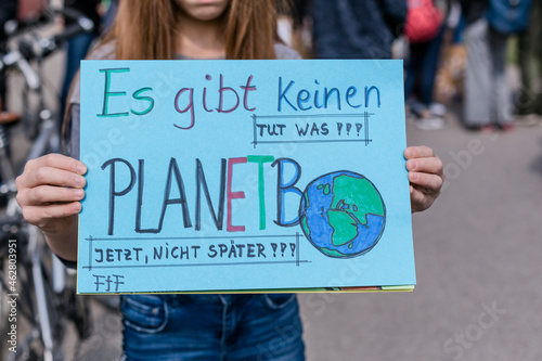 Girl holding a placard on a demonstration for environmentalism photo