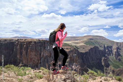 Woman hiking through the mountains, Maletsunyane Falls, Lesotho photo