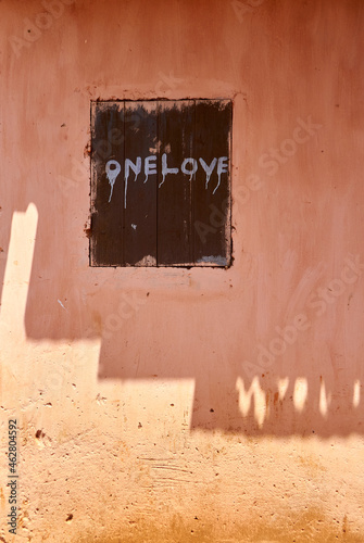 Togo, Motivational text painted on wooden window shutter photo