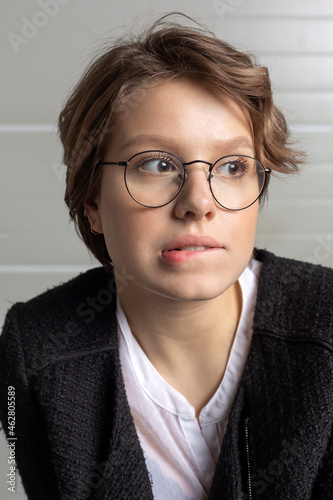 Portrait of young woman biting lip