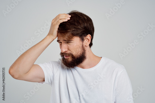 man holding his head pain stress emotions Studio treatment