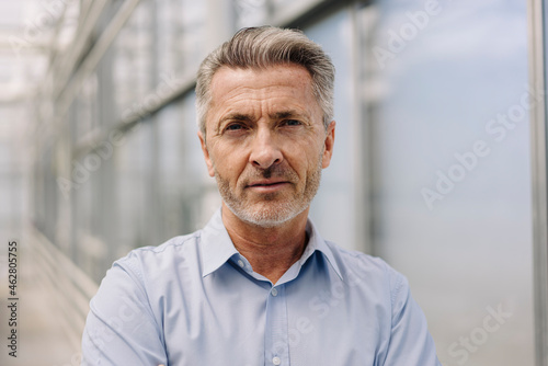 Close-up of confident male professional in plant nursery