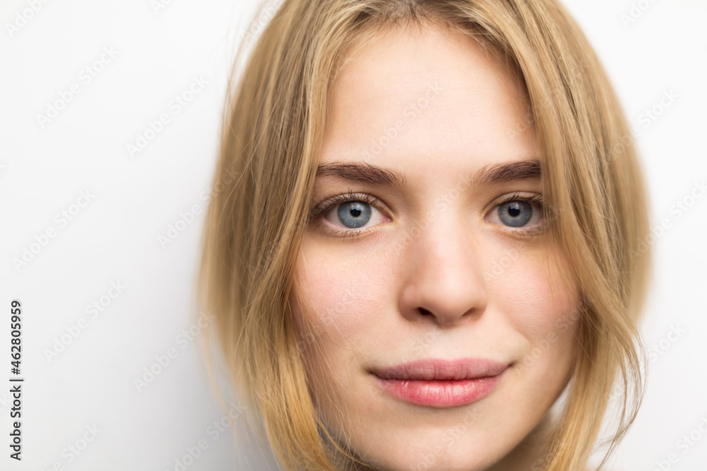 Portrait of blond young woman against white background Portrait of blond young woman against white background