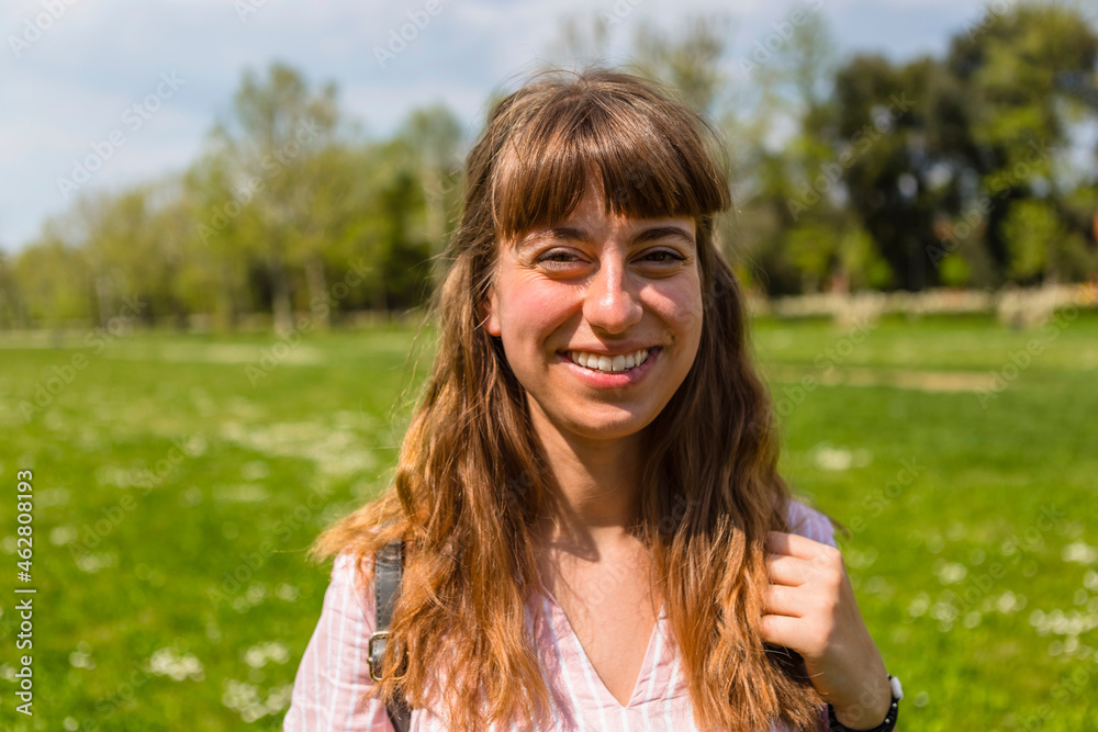 Smiling young woman in a park, portrait