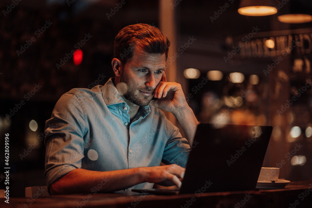 Businessman using laptop while sitting at cafe Businessman using laptop while sitting at cafe
