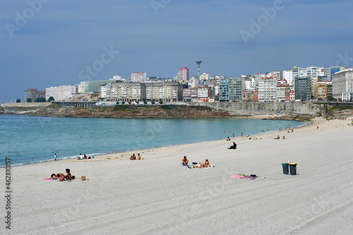 Riazor white sand beach with bathers and vacationers photo