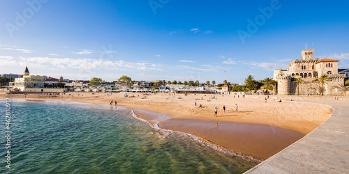 People at Tamariz Beach against sky during summer, Cascais, Lisbon, Portugal