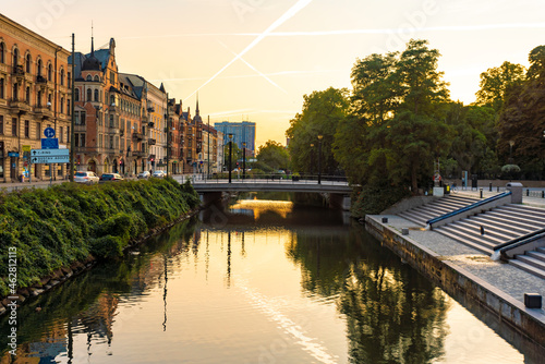 Houses by Sodra Forstadskanalen in city during sunset photo