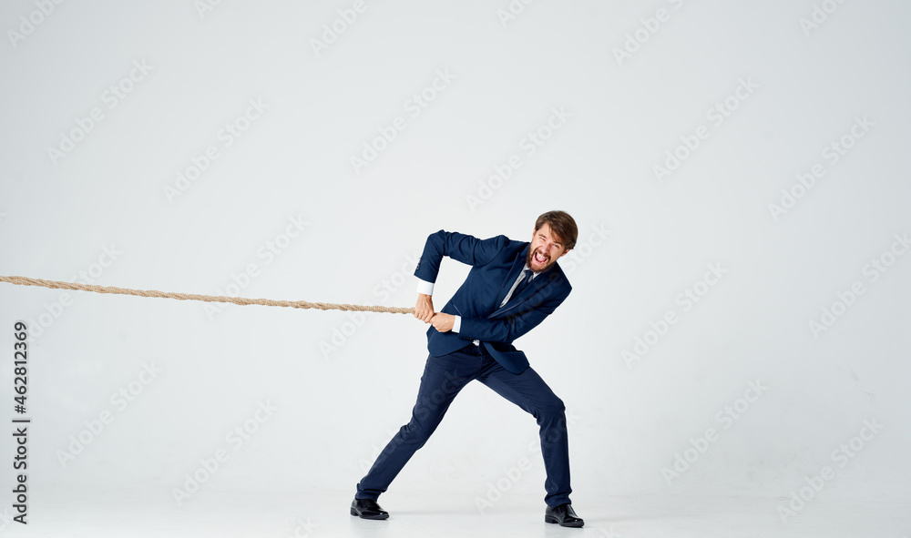 Naklejka premium business man in a suit with a rope in his hands manager office light background