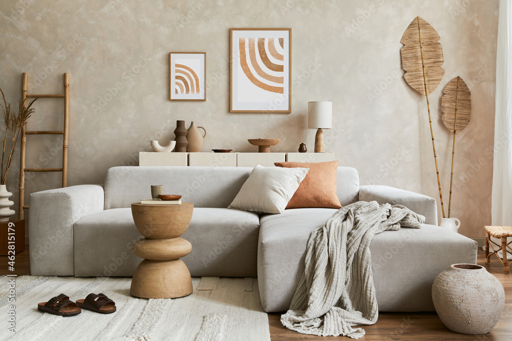 Elegnat living room interior design with mock up poster frame, grey corner sofa, coffee table and personal accessories. Pastel neutral colours. Template. - obrazy, fototapety, plakaty 