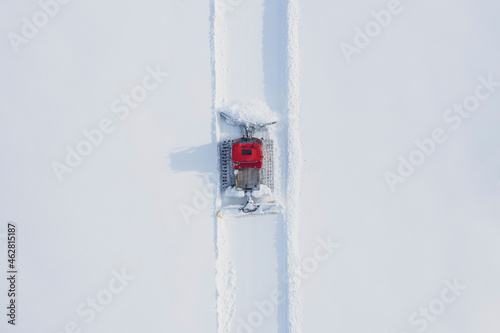 Austria, Tyrol, Galtuer, view to ski slope and snow groomer in winter, aerial view photo